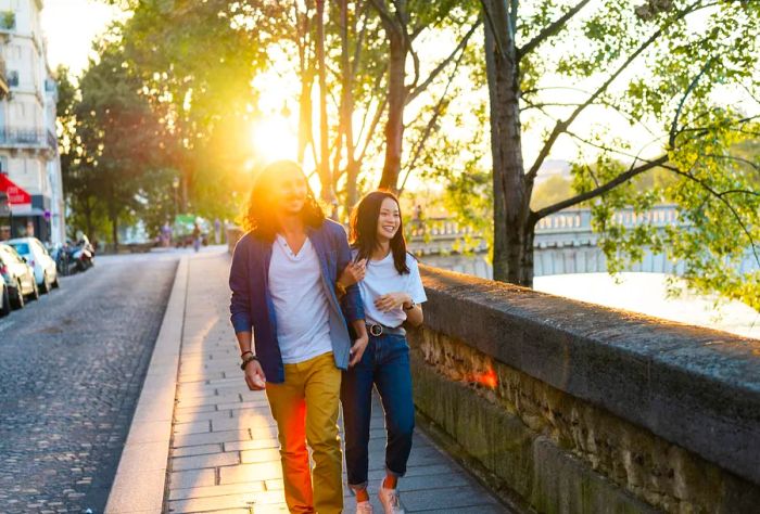 FRANCE_PARIS_PEOPLE_COUPLE_MAN_WOMAN_WALKING_ALONG_SEINE_SUNSET