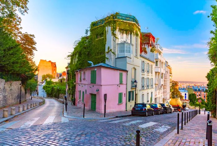 Charming street with a pink house at sunrise in Montmartre, Paris, France