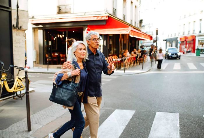 A couple strolling through the streets of Paris, France