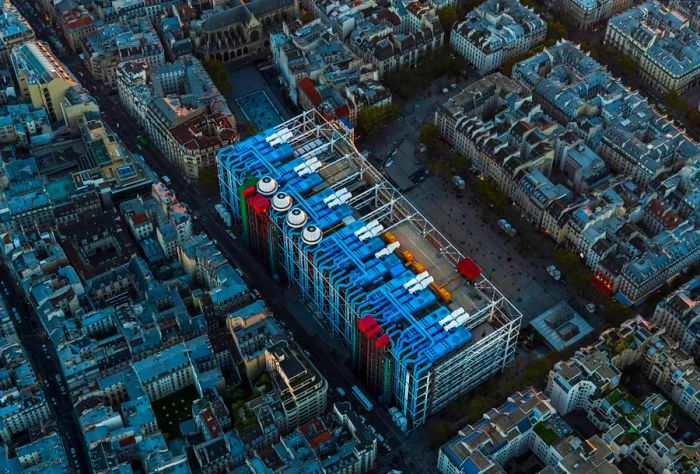 Aerial view soaring over Paris, France, showcasing the city below and Le Centre Pompidou.