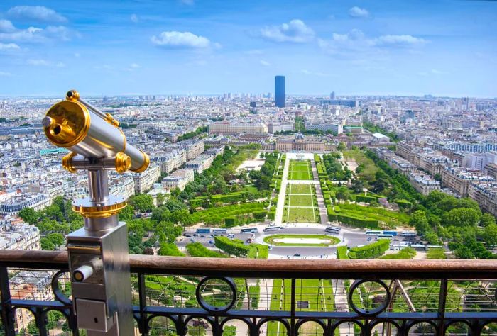 The viewing platform of the Eiffel Tower, featuring a telescope and overlooking the Champ de Mars in Paris, France