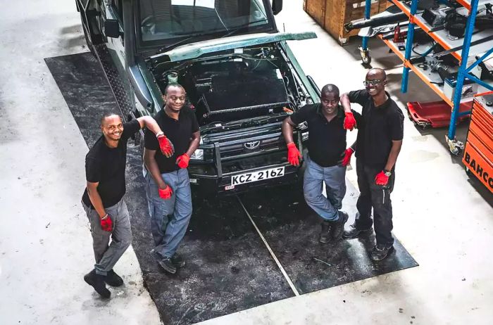 Opibus team standing proudly beside a vehicle