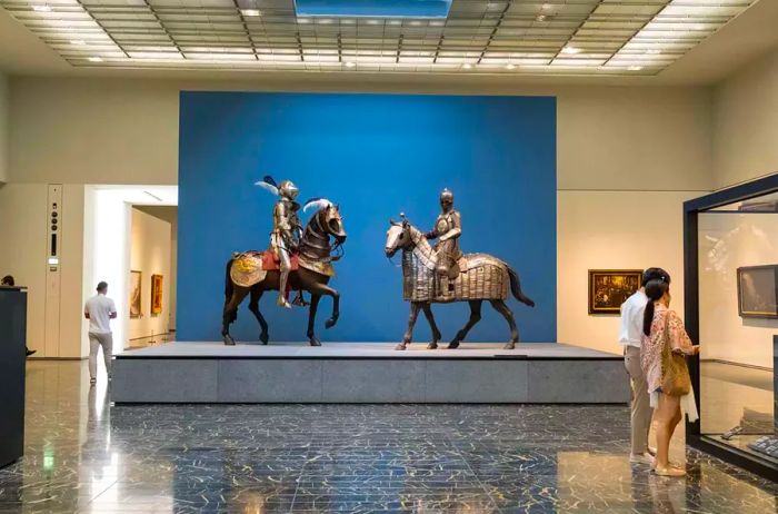 A showcase of armor at the Louvre Abu Dhabi