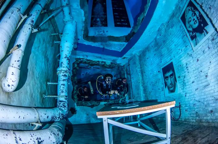 Divers exploring the sunken city at 30m in Deep Dive Dubai