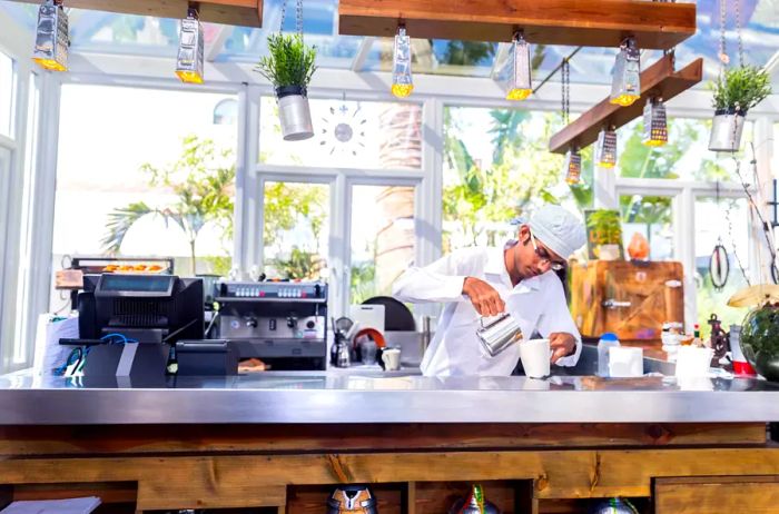 A barista preparing coffee in a Dubai café