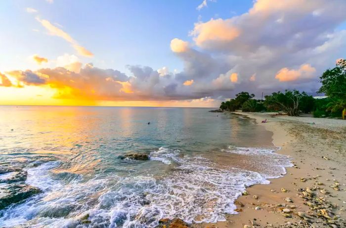 A stunning sunset view from a beach in St. Croix with gentle waves lapping at the shore.