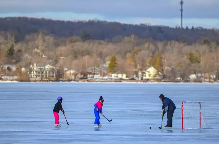 A family enjoying hockey on the frozen lake