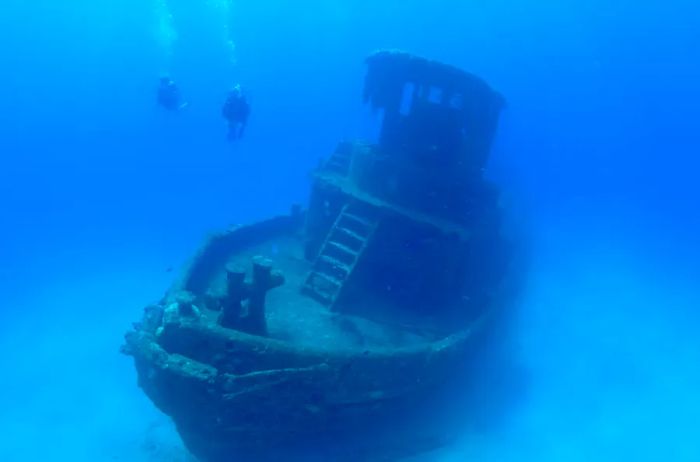 Scuba divers approach a shipwreck off the coast of St. Croix.