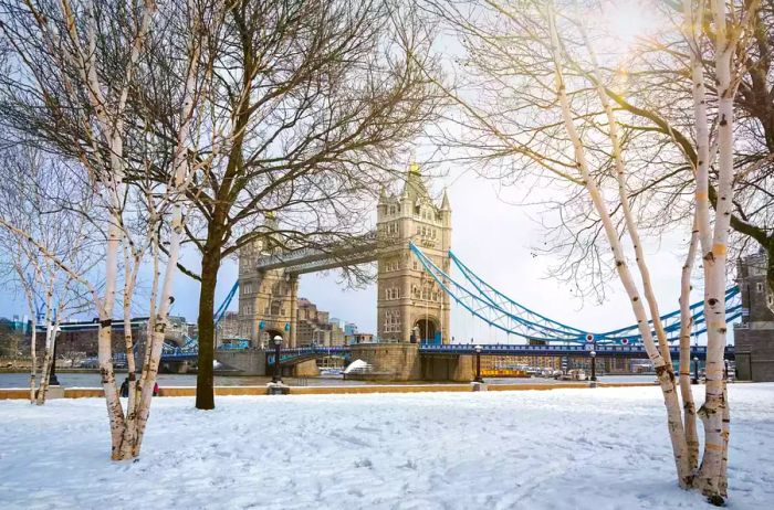 A picturesque view of the snow-covered Tower Bridge in London, UK, following a snowstorm