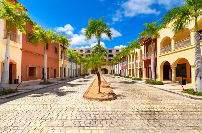 Deserted streets in Cap Cana village featuring colorful houses and beautiful nature on a sunny day. Luxurious residences in the Dominican Republic.