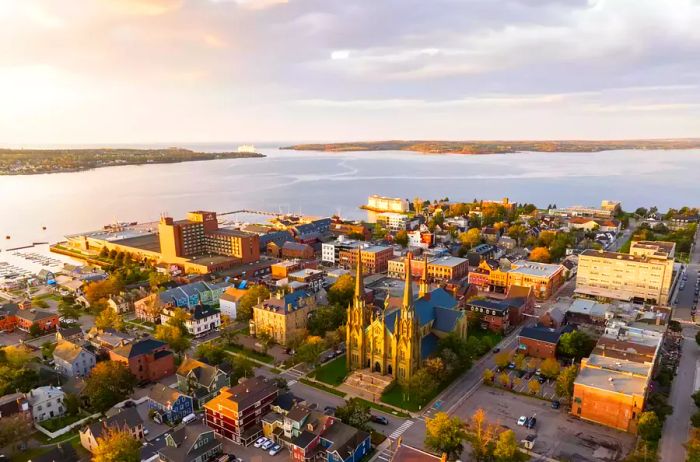 Aerial drone shot capturing downtown Charlottetown at sunrise, with a view towards the ocean