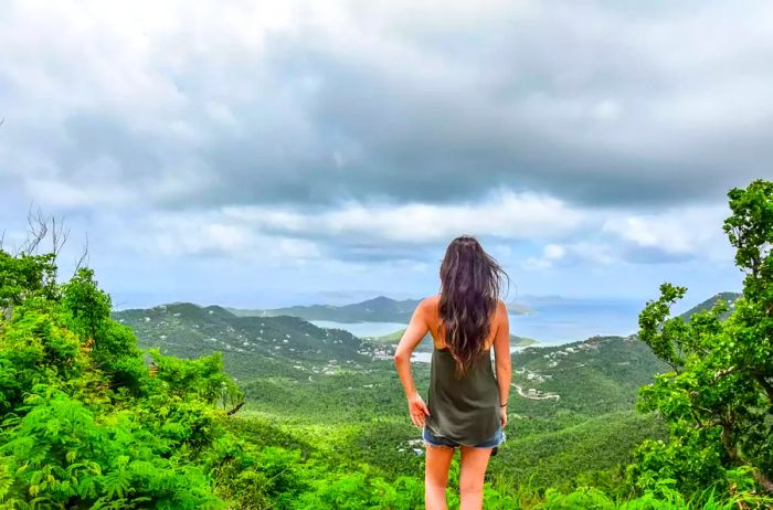 A woman standing atop a mountain in the US Virgin Islands National Park