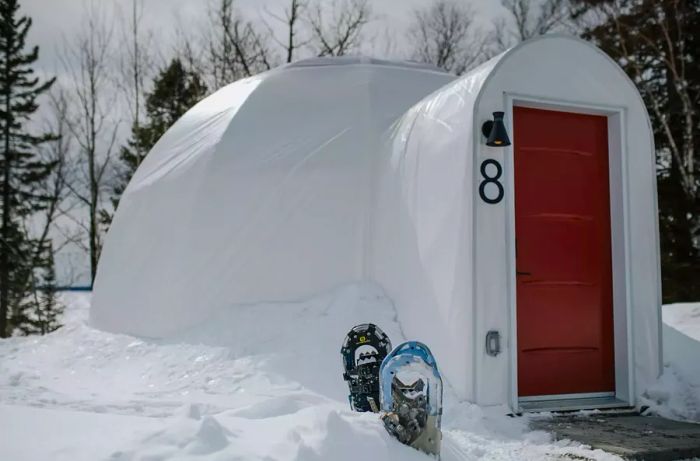 The exterior of a dome with snowshoes displayed outside at Station Boréale in Canada