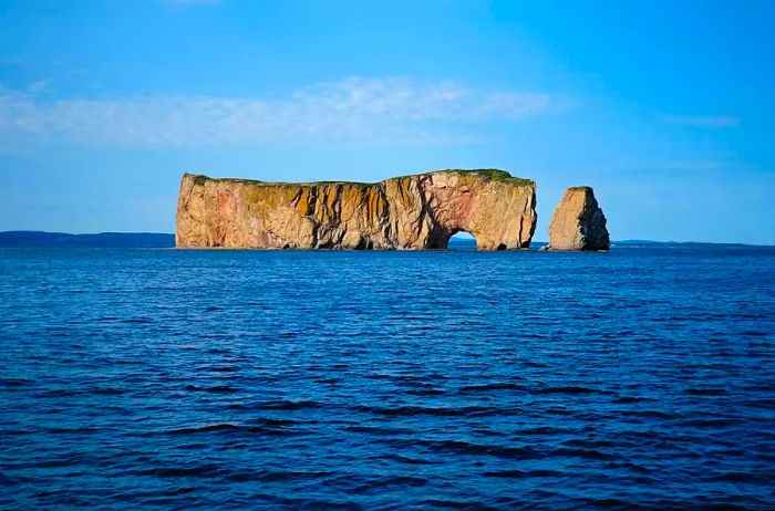 A rock formation rising from the waters off the coast of Canada