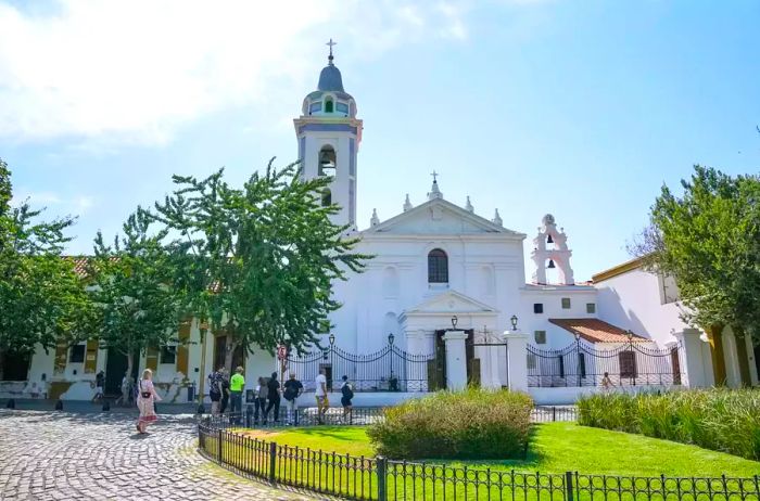 A glimpse of a church alongside a charming park in Buenos Aires