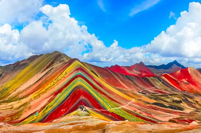 A ridgeline view showcasing the vibrant hues of Rainbow Mountain in Peru