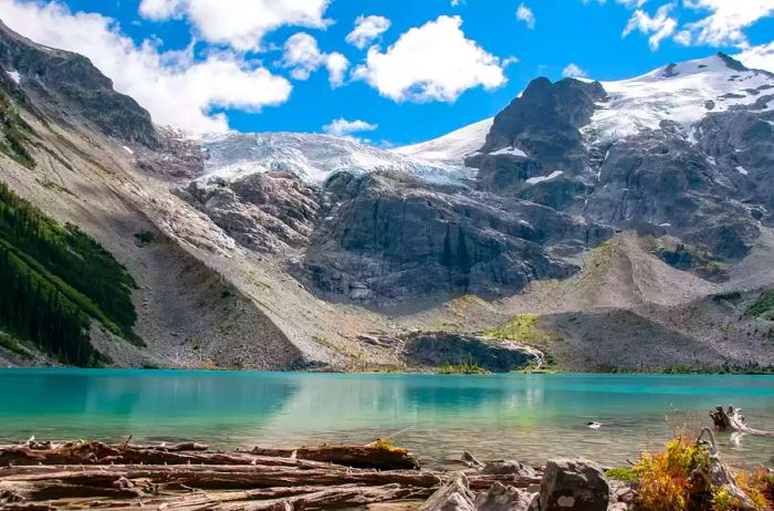 Breathtaking view of a lake surrounded by snowcapped mountains at Joffre Lakes Provincial Park, Canada