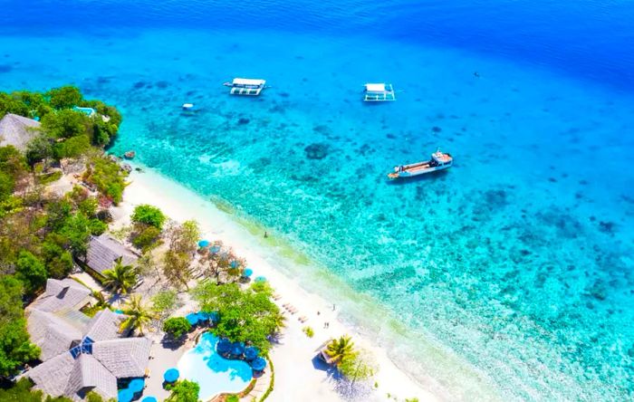 Summer Travel Inspiration: Aerial view of the pristine white sand beach and coastline at Sumilon Island, Oslob, Cebu, Philippines