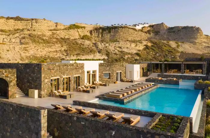 A pool terrace at Canaves Oia Epitome, located in Santorini.