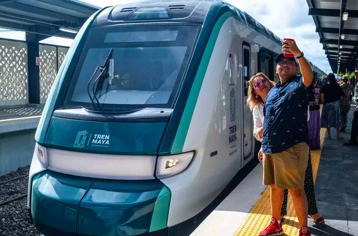 Before boarding the Maya Train at the Merida-Teya station in Teya, passengers capture a selfie.