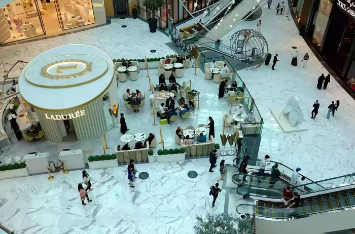 Visitors relax at an open-air coffee shop in the Dubai Mall, located in Dubai, United Arab Emirates.