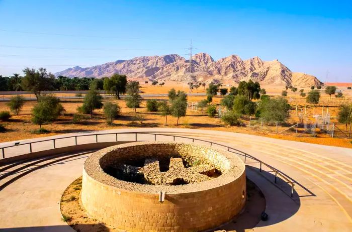 The Umm An Nar Tomb from the Bronze Age at the Mleiha Archaeological Centre, set against the backdrop of the Al Faya Mountains in Sharjah, United Arab Emirates.