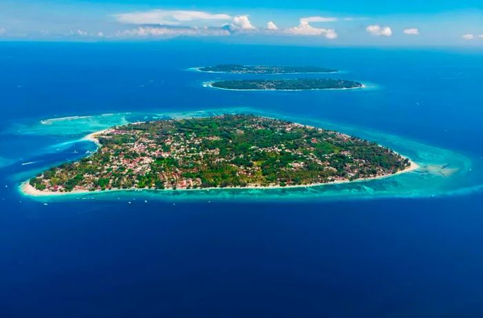 Bird's-eye view showcasing the Gili islands and the surrounding ocean: Gili Air, Meno, and Trawangan islands