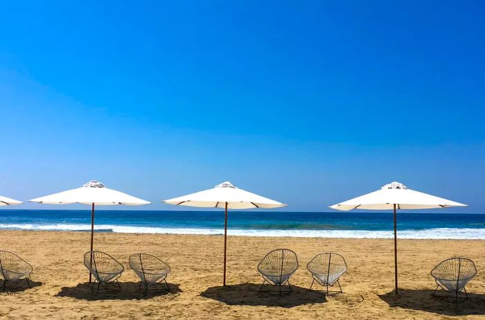 Beach Adorned with Umbrellas Overlooking the Pacific Ocean, Zipolite, Oaxaca, Mexico