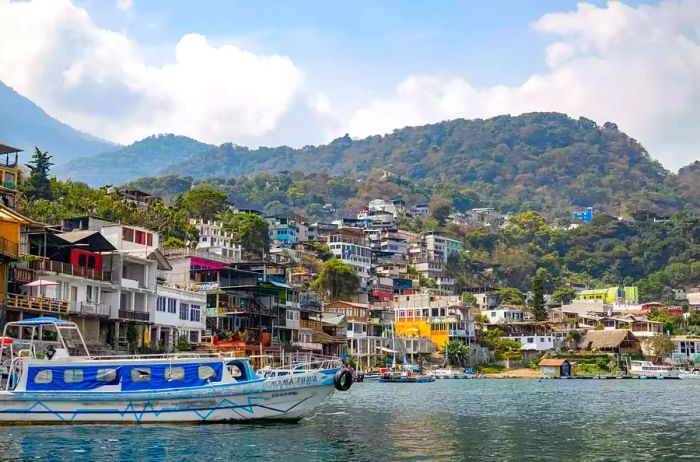 Scenic buildings and boats lining the shores of Lake Atitlan