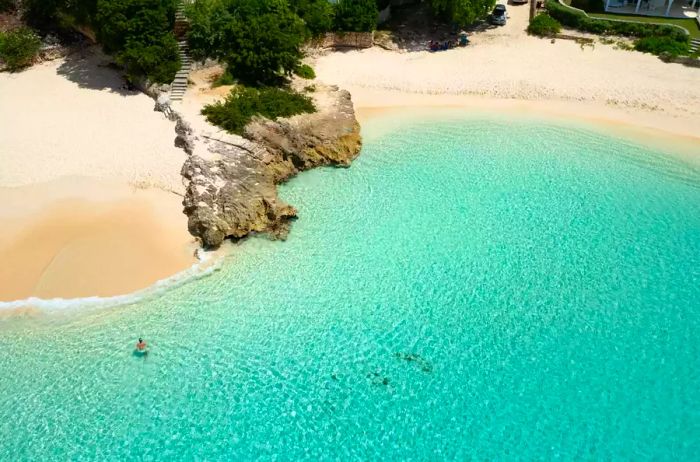 Aerial view of a woman emerging from the water at Meads Bay Beach, Anguilla