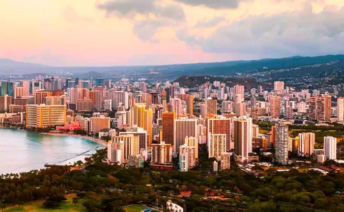 Aerial view of the city skyline and coastline during sunset