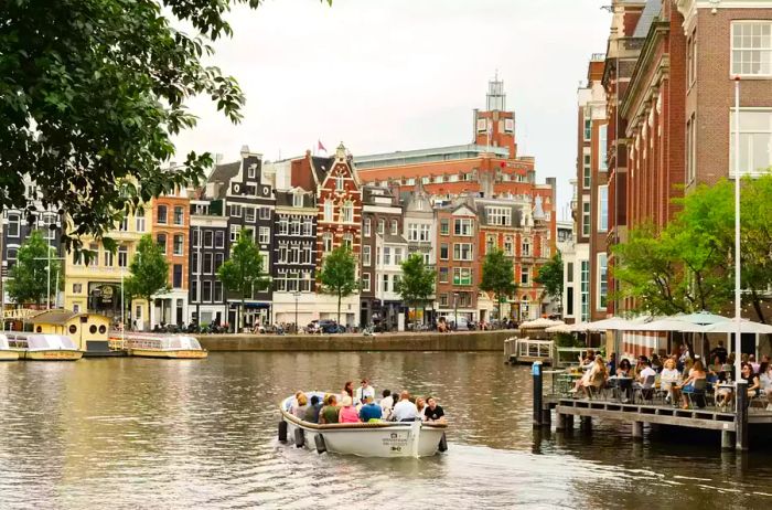 A tourist boat cruising through the charming canals of Amsterdam