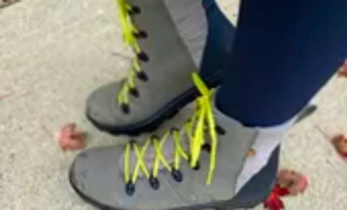 Close-up of Bogs Women's Holly Lace Leather Boots on an individual's feet