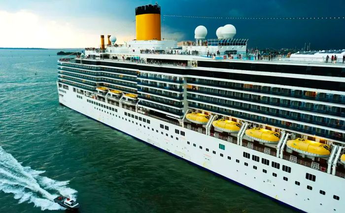 A storm approaching over the ocean, with a cruise ship docked in the harbor