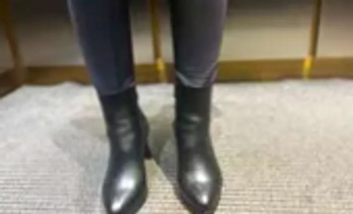 An individual wearing a pair of La Canadienne Ellenor Leather Booties