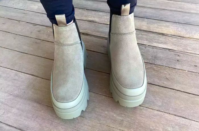 Close-up view of a person's feet clad in UGG Brisbane Waterproof Chelsea Boots