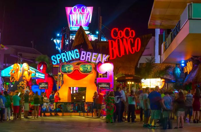 Tourists wait in long lines to enter Cancún's Coco Bongo