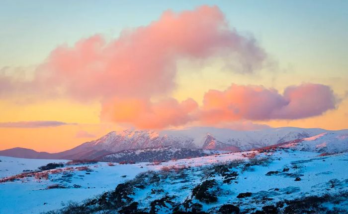 A breathtaking sunset over the snow-capped peaks in Falls Creek, Australia