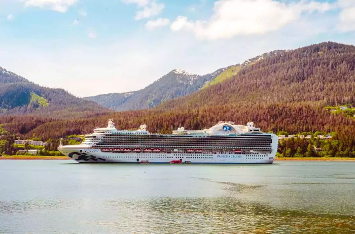 A majestic princess cruise ship navigating in front of Alaska's mountains