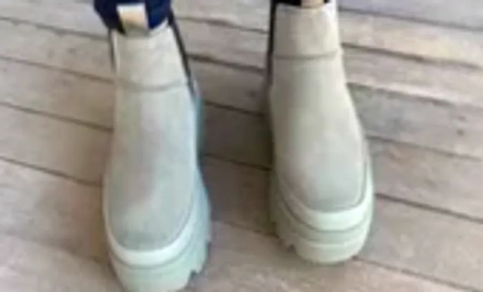 Close-up shot of a person's feet in UGG Brisbane Waterproof Chelsea Boots