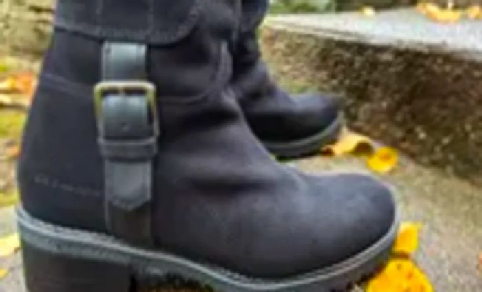 Close-up of an individual showcasing Overland Women's Major Shearling-Lined Waterproof Suede Boots