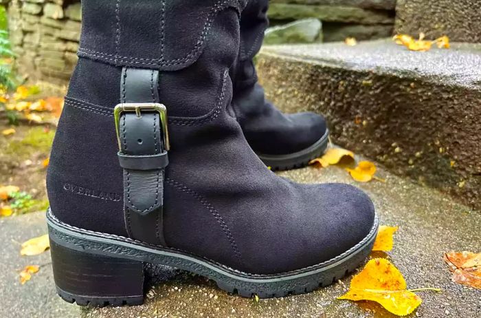 Close-up of an individual wearing Overland Women's Major Shearling-Lined Waterproof Suede Boots