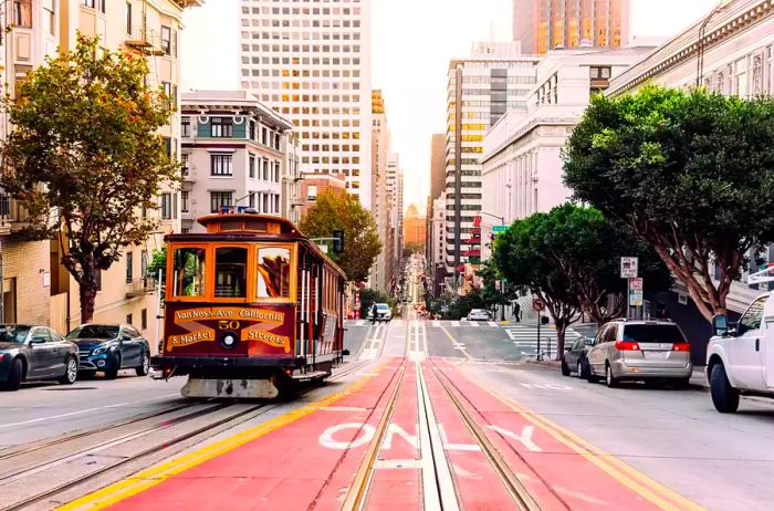 A historic cable car traveling along a street in San Francisco