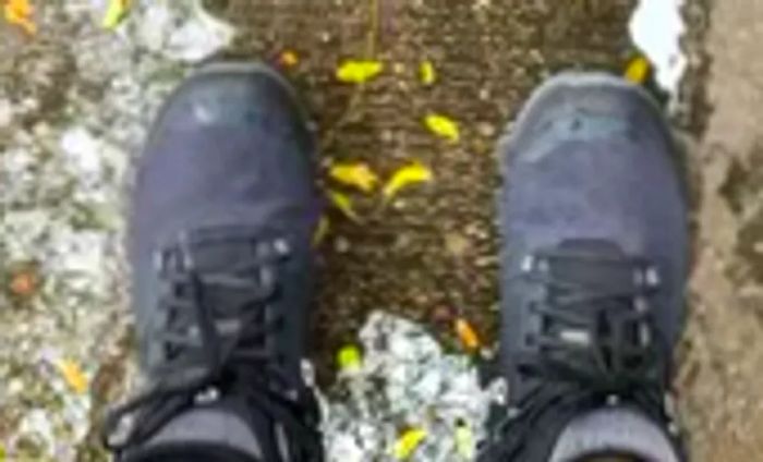 Close-up shot of On Cloudrock 2 boots being worn on a person's feet