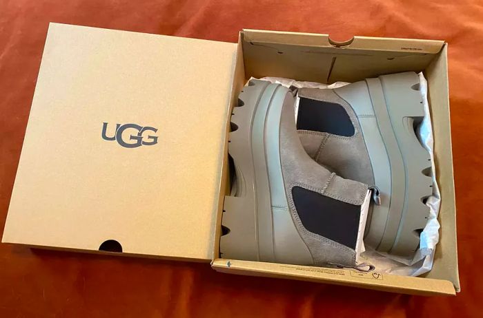 A pair of UGG Brisbane Waterproof Chelsea Boots displayed in their box