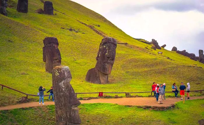 Hikers exploring the iconic stone figures on Easter Island, Chile