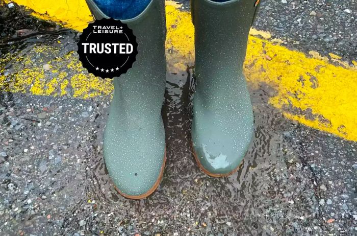 A person sporting waterproof boots on a rainy street