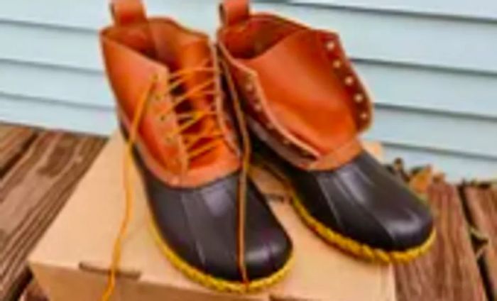 A pair of L.L. Bean Women's 6-Inch Bean Boots resting on their box