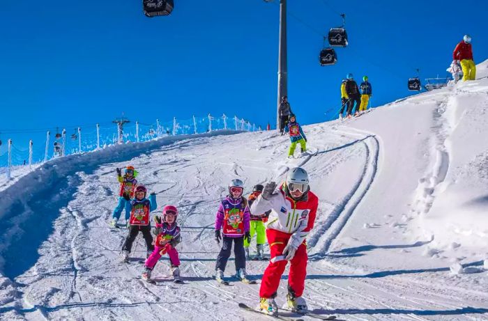 Kids enjoying ski lessons on a snowy slope