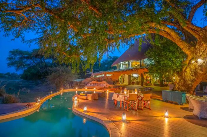 Dining area next to a pool in a safari-style house